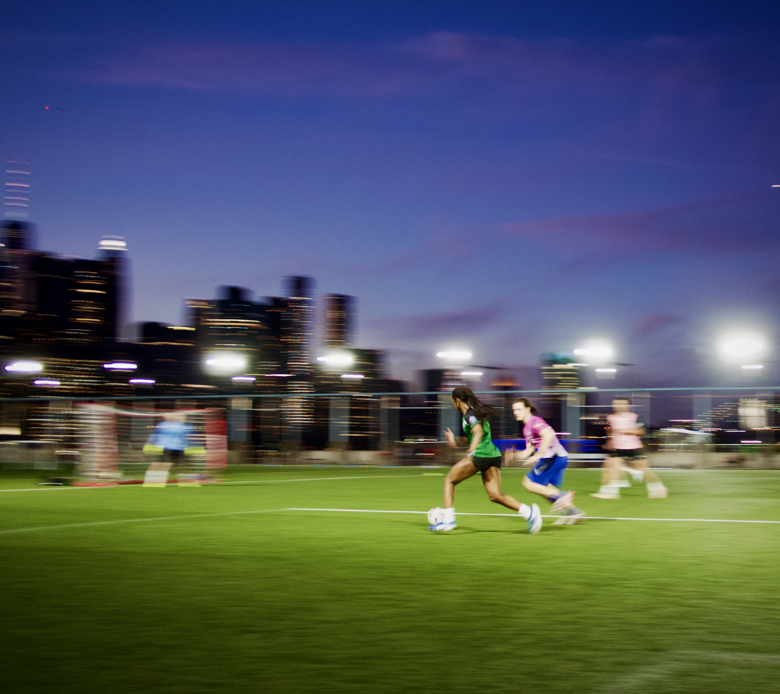 Players running during pickup soccer at Brooklyn Bridge Park
